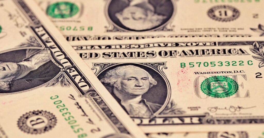 Detailed close-up of US one dollar bills showcasing intricate design and texture.