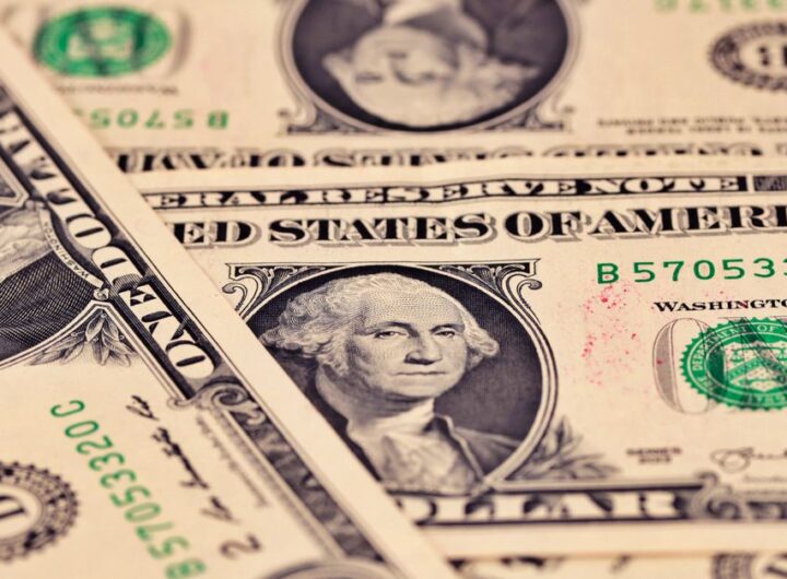 Detailed close-up of US one dollar bills showcasing intricate design and texture.