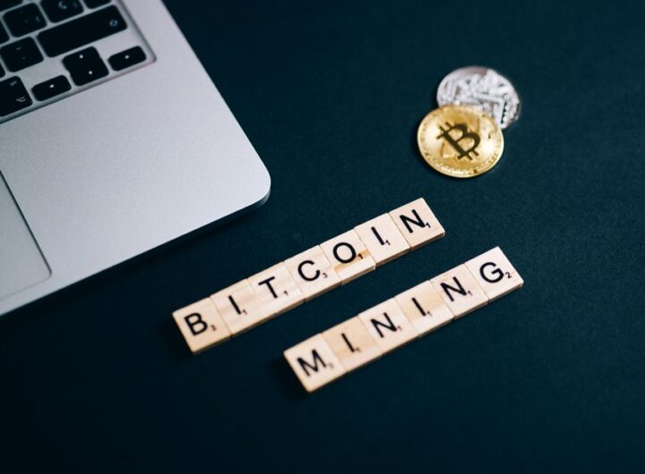 Top view of Bitcoin mining concept represented with laptop keyboard and Scrabble tiles.
